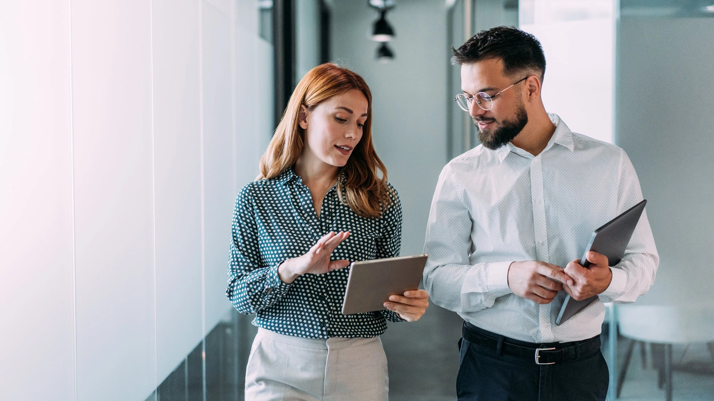 Two professionals discussing a project in an office